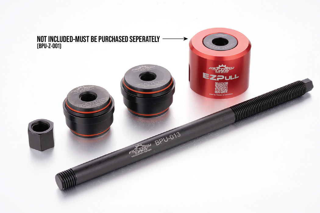 A motorcycle hardware kit on a white background, featuring a red anodized EZPULL brand cylinder, a black threaded rod, two black and red stacked collars, and a small black hex nut. A text overlay states 'NOT INCLUDED-MUST BE PURCHASED SEPARATELY (BPU-Z-001)'.