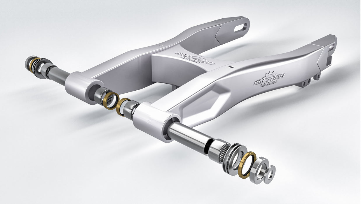 Exploded view of a motorcycle swingarm assembly showing needle bearings, collars, seals, and pivot components from a swingarm rebuild kit.