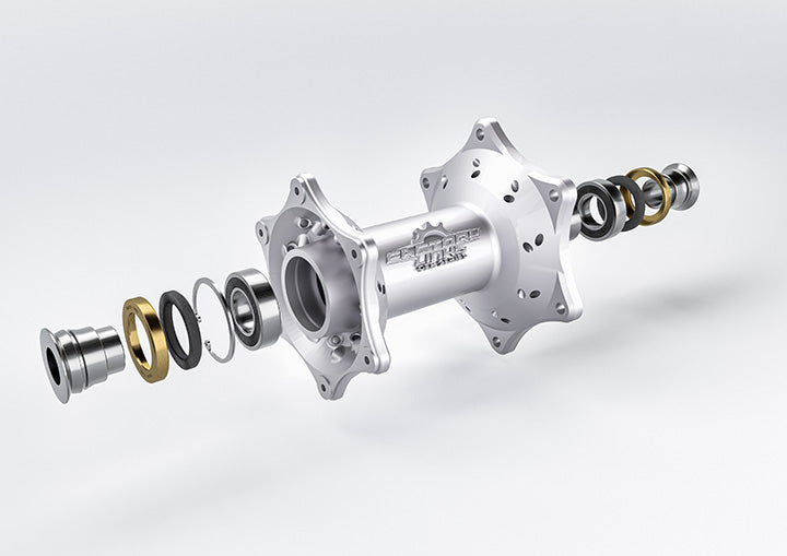 Exploded view of Factory Links OEM Series Rear Wheel Bearing Kit on a hub with bearings, spacers, and seals installed.